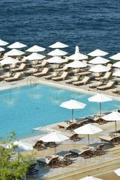 Pool, sea nd loungers Stock Photos