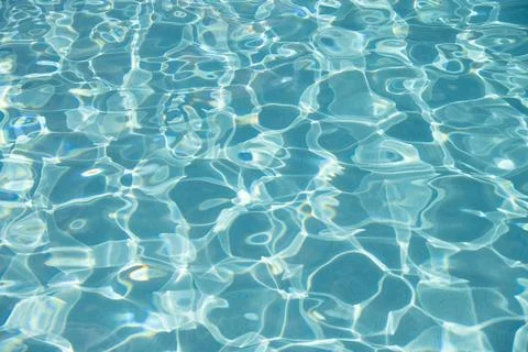 Pool side resort with pool water surface background. Sea ripples on blue pool Photos