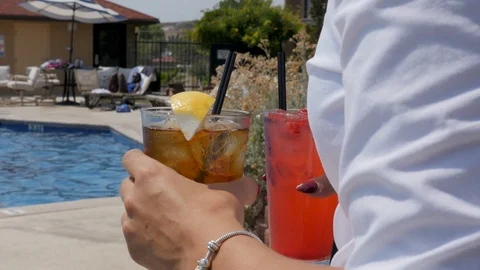 Pool side service drinks taken to senior couple focus on drinks Video stock 94232472