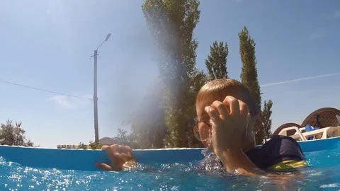 In the pool sinking boy in clothes with glasses Stock Footage 111548405