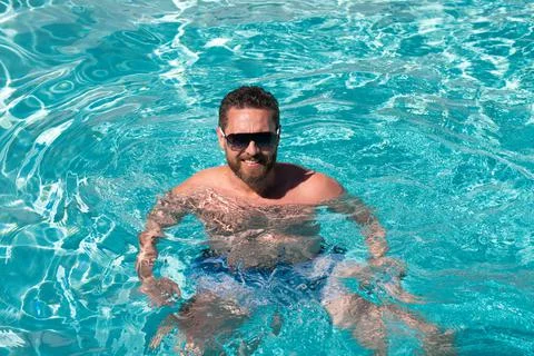 Pool spa resort. Summertime vacation at pool. Summer weekend. Handsome man in Stock Photos