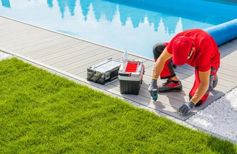 Pool Specialist Installing the Composite Deck Stock Photos