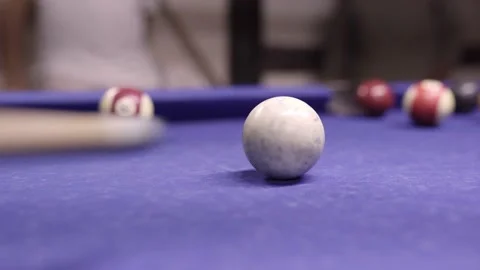 Pool stick hitting the white ball and scoring during a billiards table Stock Footage 221785764