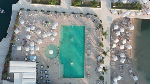 Pool in a summer luxury beach resort and spa - aerial top down view Stock Footage 213833401