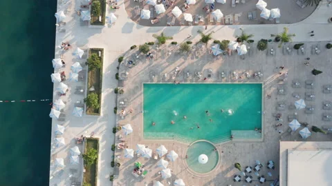 Pool in a summer luxury beach resort and spa - aerial top down view Stock Footage 213847425