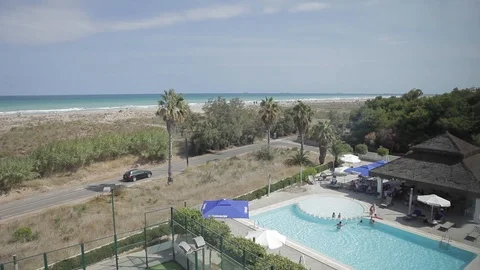 Pool in summer next to the turquoise mediterranean sea Stockbeeldmateriaal 109549803