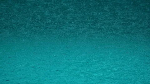 Pool surface under heavy rain. surface of the sea under the falling raindrops. Stock Footage 120012930