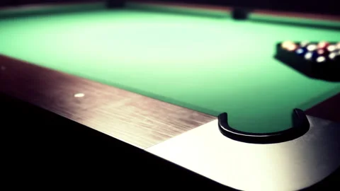 Pool table with balls ready for a game in a dimly lit room Stock Footage 344060233