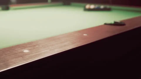 Pool table with balls set for game in dimly lit room during evening Stock Footage 344159328
