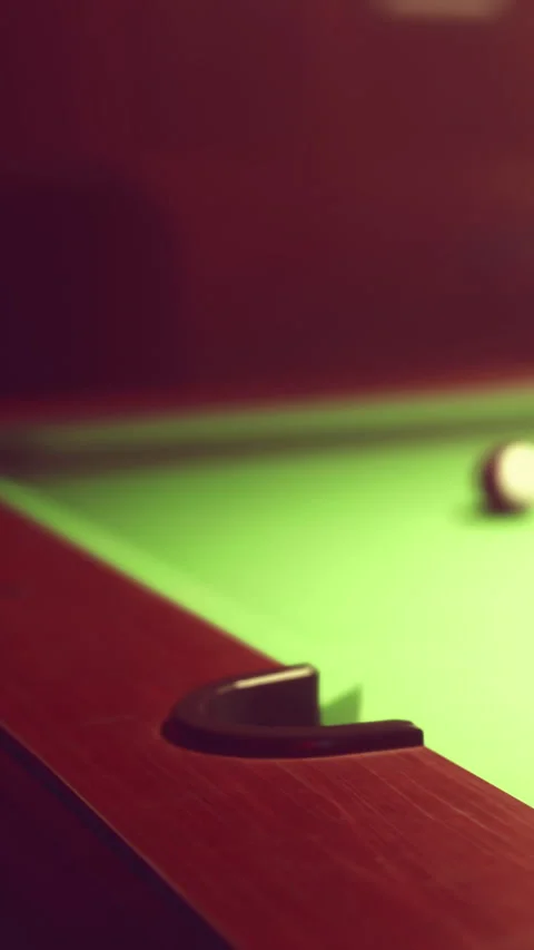 Pool table with cue ball in focus during a game at night Stock Footage 339508223