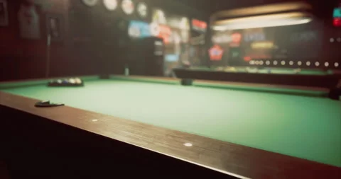 Pool table in a dimly lit bar with retro decorations and vibrant neon signs Stock Footage 311801493