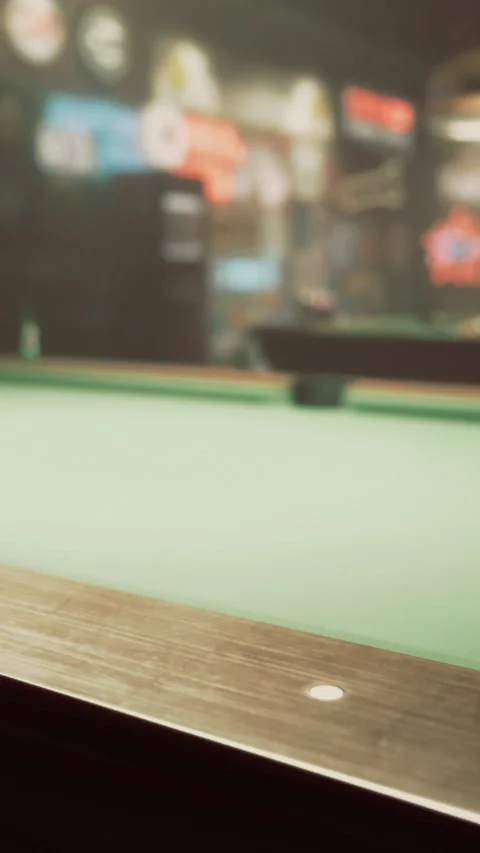 Pool table in a dimly lit bar with retro decorations and vibrant neon signs Stock Footage 329939706