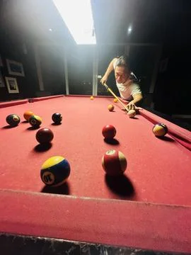 Pool table in the night with a man playing Stock Photos