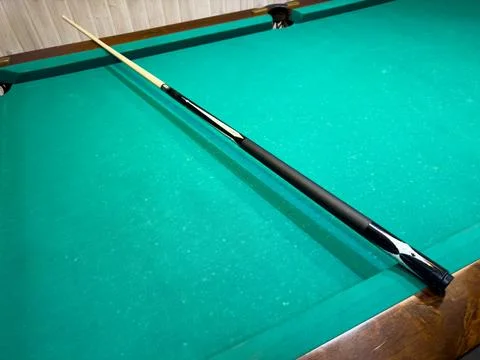 A pool table with a pool stick on it Stock Photos
