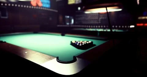 Pool table set with balls in a dimly lit bar during evening hours Stock Illustration