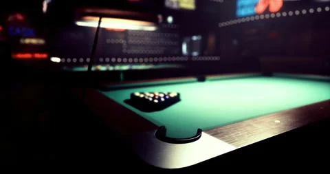 Pool table set up in a dimly lit bar with vibrant background lights Stock Footage 304526448