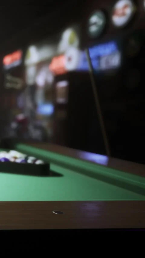 Pool table set up for a game in a busy bar during the evening hours Stock Footage 334105209