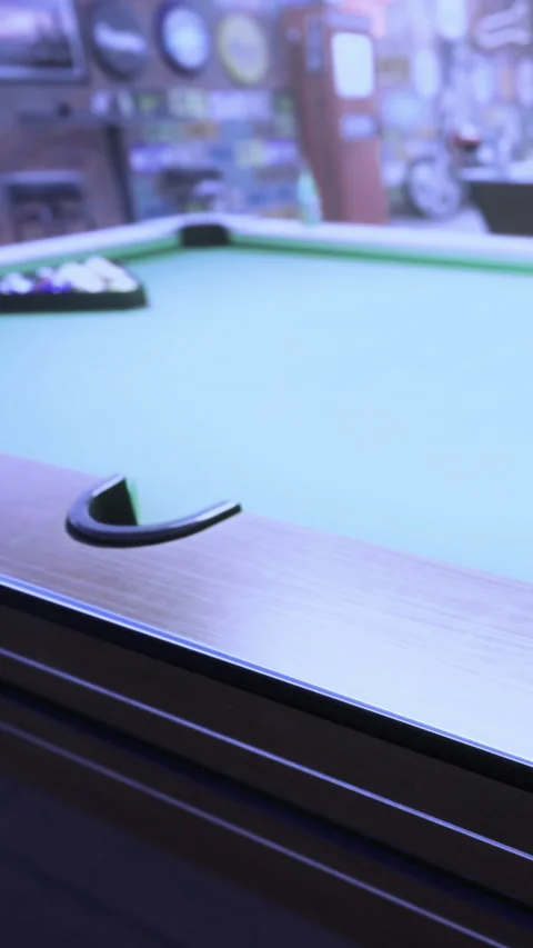 Pool table set for a game in a local bar during evening hours Stock Footage 336187109