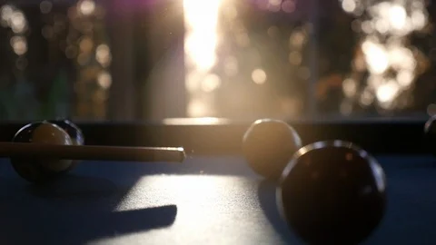 Pool Table Slow Motion Cue Ball Hit with Sunset Lens Flare Bokeh Handheld Stock Footage 85583550
