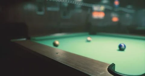 Pool table with three balls in a dimly lit game room setting Stock Illustration