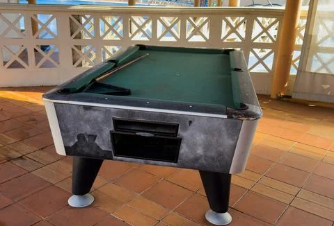 Pool table without balls in the hotel in the open air under a canopy. Stock Photos