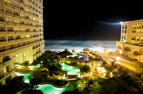 Pools at a beach front hotel at night Stock Photos