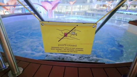 Pools Closed Warning Sign Hanging Over Cruise Ship Hot Tub at Night Vídeo Stock 345932204