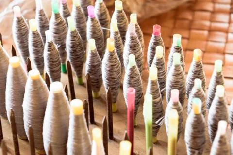 Pools of silk thread waiting to be woven back into their pattern Foto stock
