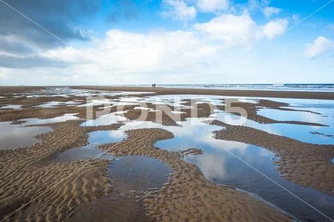 Pools of water making patterns on the beach at Holkham Bay, North Norfolk coast, Stock Photos