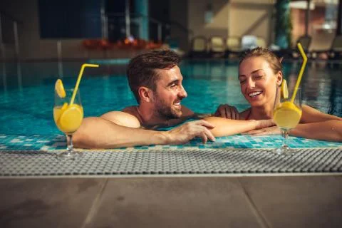 Poolside drinks and laughs Stock Photos