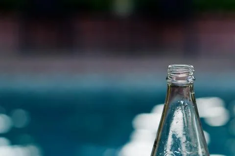 Poolside glass bottle Stock Photos