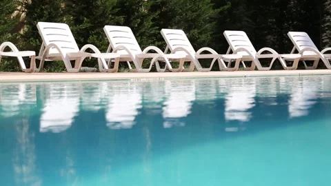 Poolside Lounge Chairs Under Sunlight Stock Footage 339703754