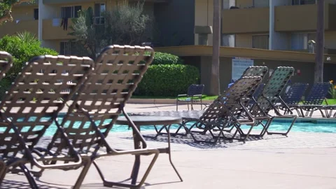 Poolside view of empty lounge chairs arranged in rows in California, USA in.. Stock Footage 282027104