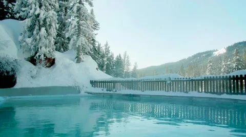 Poolside View of Mountains and Blue Sky in the Snow Tracking Shot Stock Footage 64822111
