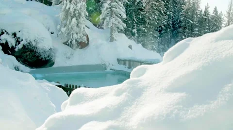 Poolside View of Mountains and Blue Sky in the Snow Tracking Shot Stock Footage 64822470