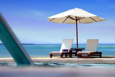 Poolside view near the beach with blue sky Stock Photos