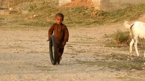 Poor Afghani Kid Running With Tire In Punjab, Pakistan. 14 April 2025 Stock Footage 306656667