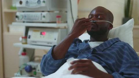 Poor afro-american weak sweaty patient taking in medicine to decrease painful 動画素材 142595977