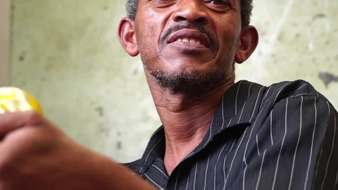 Poor Aged Man Playing and Drumming a Can Stock Footage 84762286