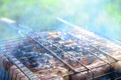 Poor and improper cooking meat on fire. Toasted meat with overcooked crust Foto stock