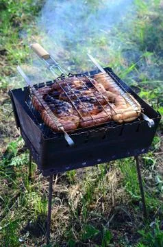 Poor and improper cooking meat on fire. Toasted meat with overcooked crust Stock Photos