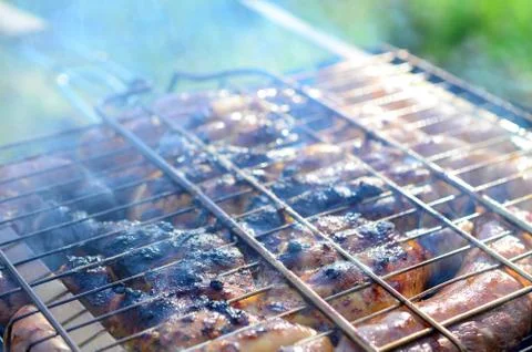 Poor and improper cooking meat on fire. Toasted meat with overcooked crust 写真素材