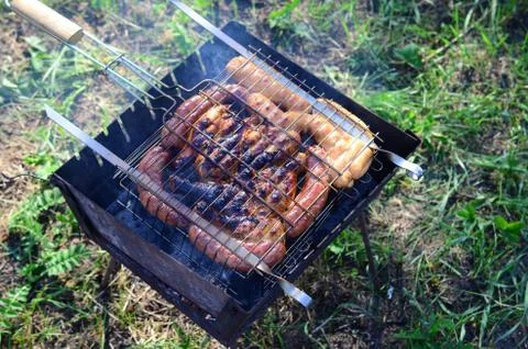 Poor and improper cooking meat on fire. Toasted meat with overcooked crust Stock Photos