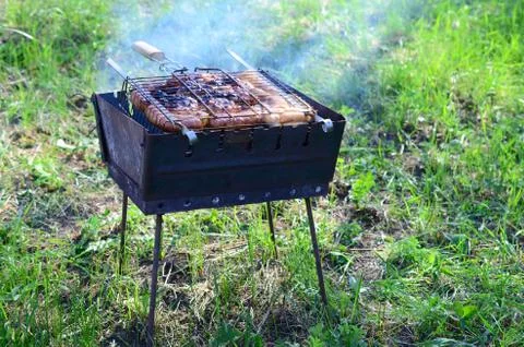 Poor and improper cooking meat on fire. Toasted meat with overcooked crust 写真素材