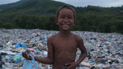 Poor Asian Boy Smiling With Garbage Dump 스톡 동영상 153701805