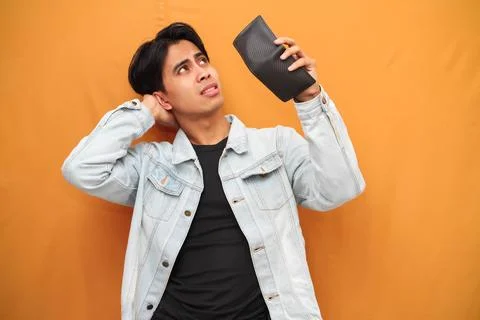 Poor Asian man posing holding empty wallet, Asian man holding empty wallet .. Stock Photos