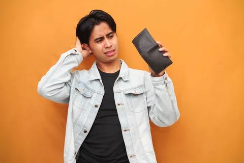 Poor Asian man posing holding empty wallet, Asian man holding empty wallet .. Stock Photos
