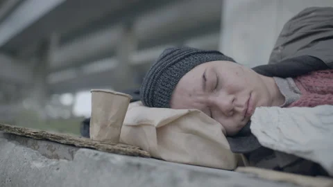 Poor beggar sleeping on the ground, basic needs, social problem, economic crisis Stock Footage 143078469
