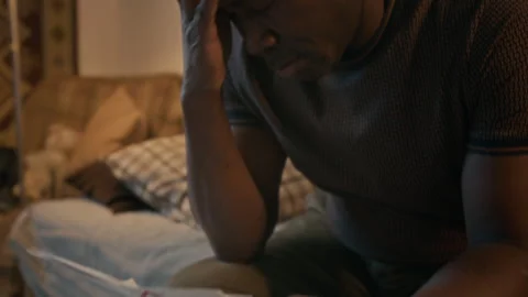 Poor Black man Feeling Anxious About his Past Due Bills and Eviction Notice Stock Footage 306153183
