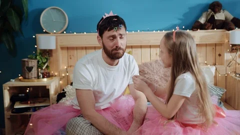 Poor bored daddy crying waiting while his daughter putting accessories on his Stock Footage 112264318